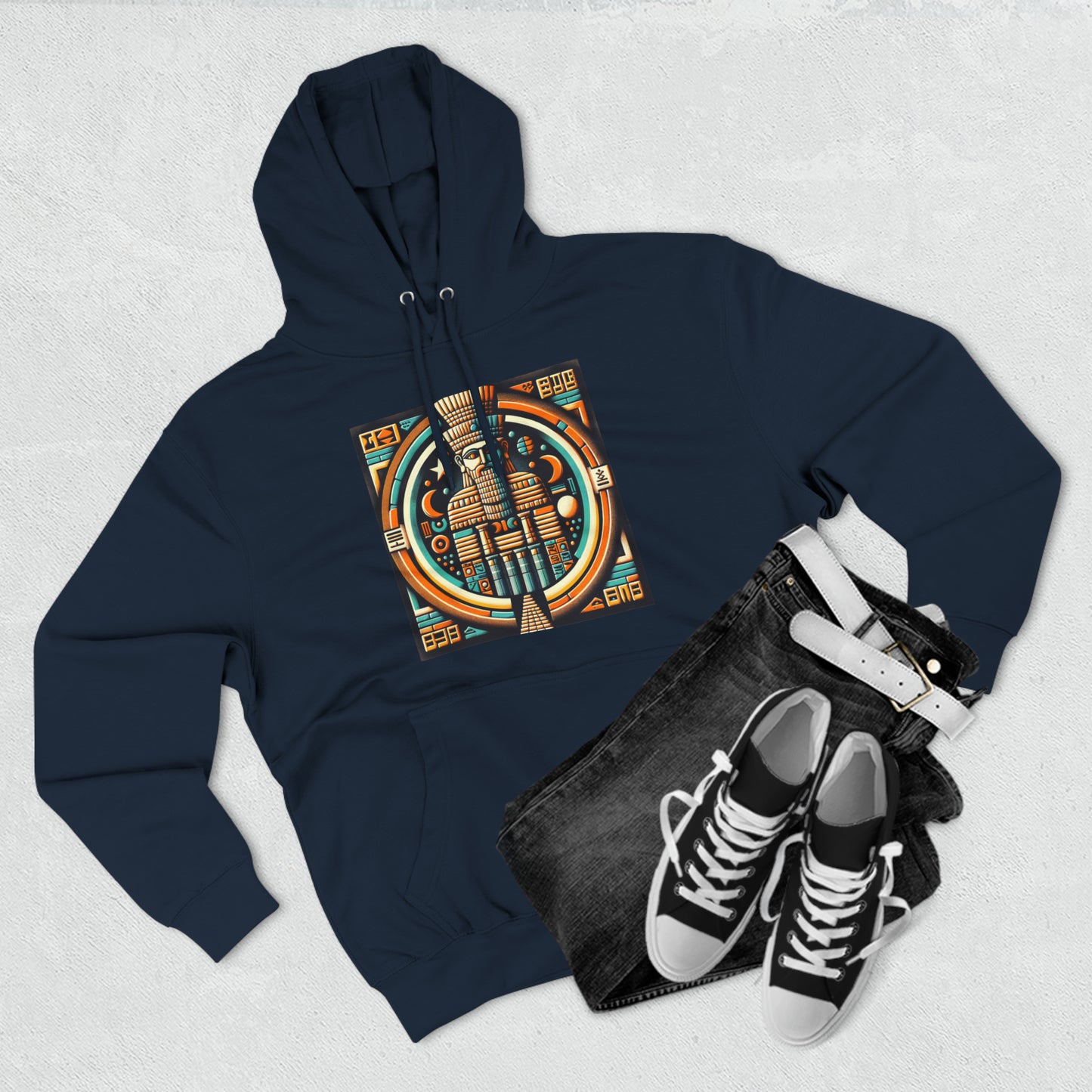 Navy hoodie with graphic of Anu (An), the Mesopotamian sky god and father of deities like Enki, Enlil, and Inanna paried with jeans and shoes.