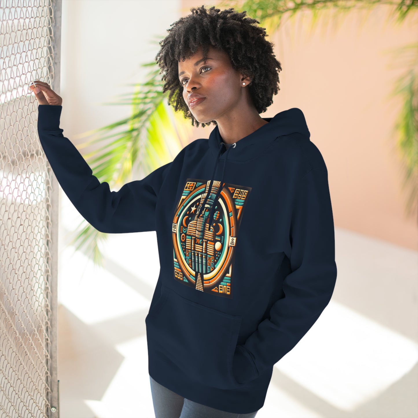 Woman wearing navy hoodie with graphic of Anu (An), the Mesopotamian sky god and father of deities like Enki, Enlil, and Inanna.