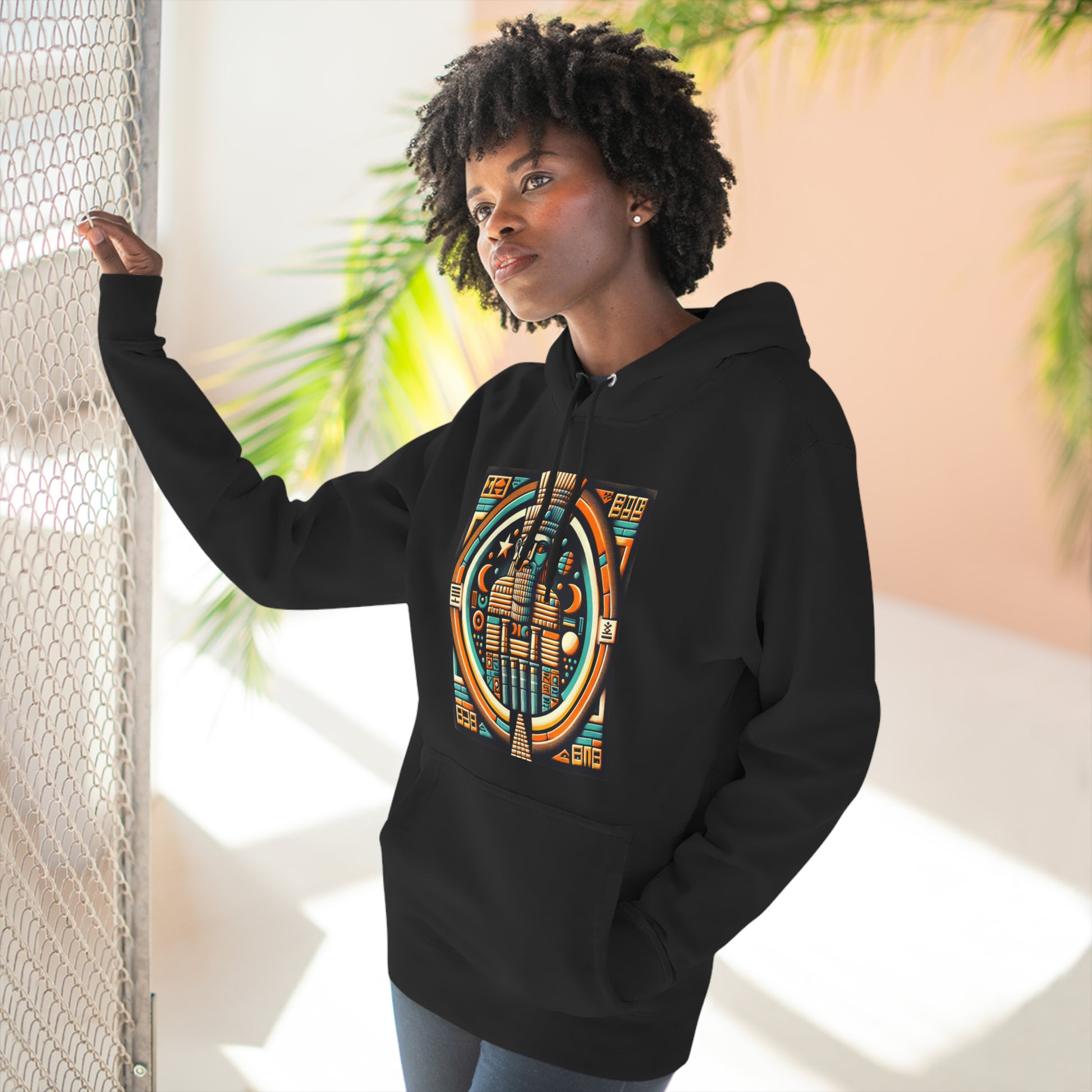 Woman wearing black hoodie with graphic of Anu (An), the Mesopotamian sky god and father of deities like Enki, Enlil, and Inanna.